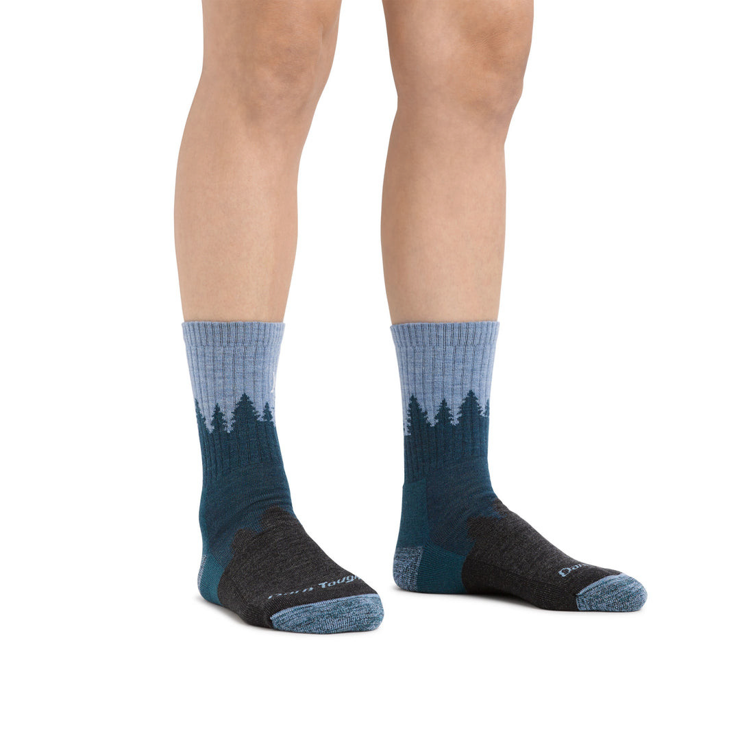 Outdoors Oriented Darn Tough women's merino wool hiking socks with a blue forest landscape pattern and cushioned foot