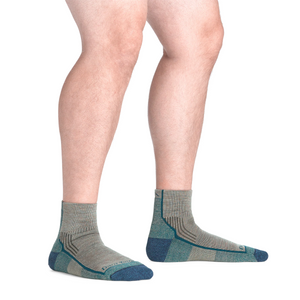 Outdoors Oriented Darn Tough 1959 Hiker quarter socks in grey and blue merino wool blend on a man's feet
