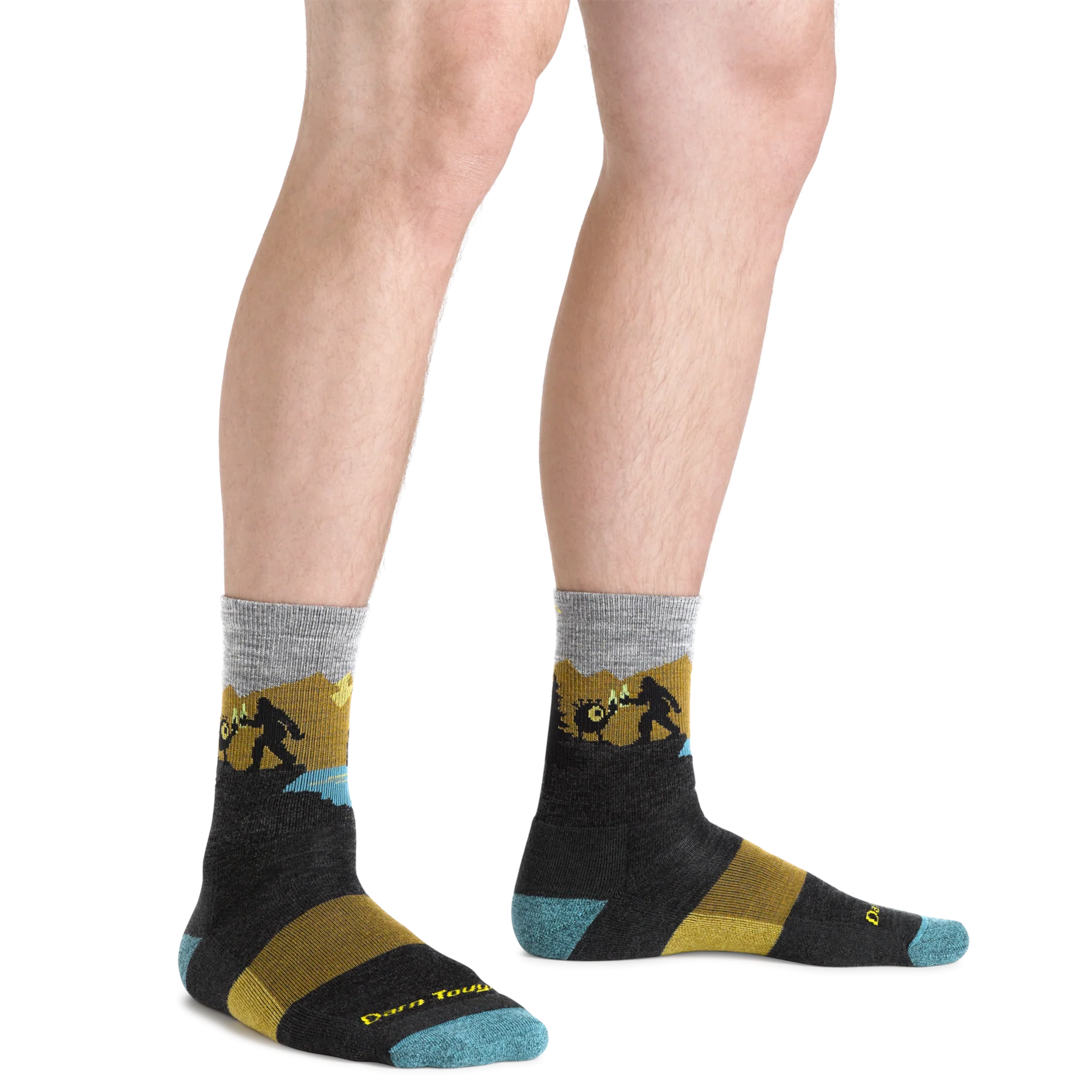 Outdoors Oriented Darn Tough Close Encounters merino wool hiking socks with Bigfoot graphic on a man's legs