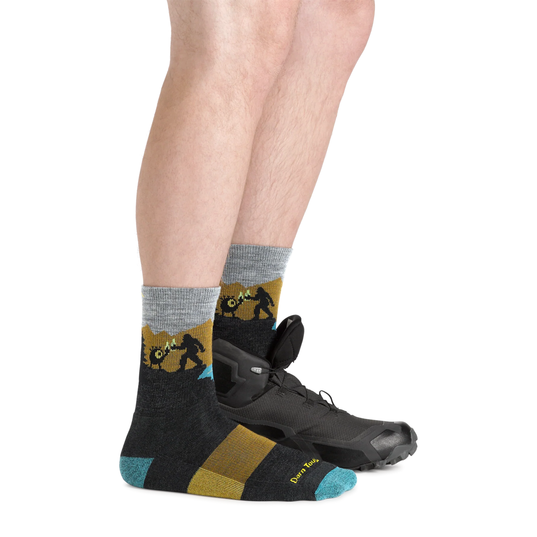 Outdoors Oriented Darn Tough Close Encounters merino wool hiking socks with Bigfoot graphic on a hiker's leg